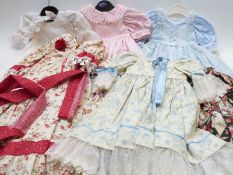 Eight children's or large dolls' dresses and outfits, most with floral patterns