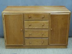 Ercol style Arts & Crafts light elm or similar sideboard having four drawers flanked by cupboards,