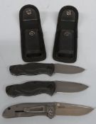 Two Waltner pocket knives with canvas sheaths together with a CRKT Drifter example