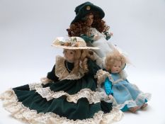 Three bisque collectors' dolls two by Cindy McClure and one other similar, largest 50cm tall on