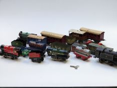 Seventeen Hornby 0 gauge tinplate locomotives, coaches, wagons, vans and tankers including BR
