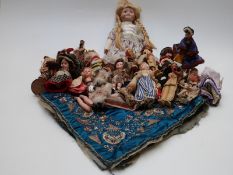 Twenty four various dolls of the world and souvenirs