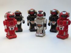 Six Magic Mike II battery operated robots in black, red and silver