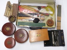 A boxed two drawer drawing set marked WH & S, measuring tapes, slide rules etc