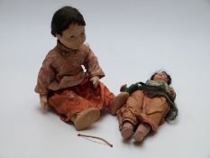 Two lacquer dolls, one Japanese with painted features and silk outfit (40cm tall) the other Indian