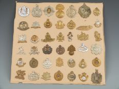 Approximately 50 British Army cap badges including the 'Buffs', Gloucestershire Regiment, 4 Royal