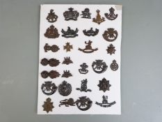 Twenty eight British Army officers' cap and collar badges including Royal Gloucestershire Hussars,