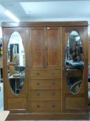Edwardian mahogany Sheraton style triple wardrobe set with ornate inlay of scrolling fauna, the
