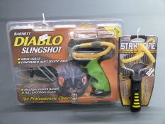 Two Barnett slingshots/catapults Diablo and Strike Nine, both new in original packaging