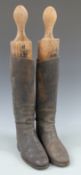A pair of vintage leather riding boots with trees, approximately size 8