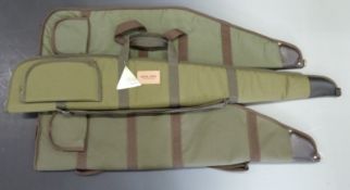 Three padded shotgun/ rifle slips one Jack Pyke and two wool lined, all with shoulder straps and