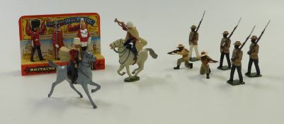 Nine Britains diecast model soldiers comprising six Gurkhas and three Queen's Guards on original