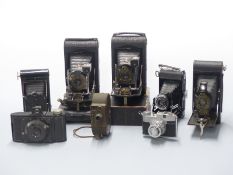 Seven folding and other collectable cameras including Kodak, Wembley Sports, Comet 5, and Bell &