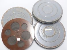 Three vintage Laurel & Hardy 16mm cine film reels marked 'Charlie Detective', 'Brats' and 'Busy