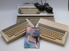 Four vintage personal computers comprising Atari 520ST, Commodore Amiga A1200 and two Acorn