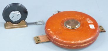 Two Rabone Chesterman tape measures, one 100ft the other on stand marked Monmouthshire County
