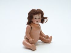 Heubach Koppelsdorf bisque headed doll with open mouth, weighted brown eyes, long brown hair and