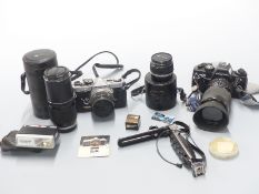 Olympus OM-2 SLR camera with 50mm 1:1.8, 28mm 1:3.5 and 200mm 1:4 lenses and Praktica BX20 SLR