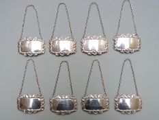 Set of eight hallmarked silver bottle tickets comprising whisky, vodka, port, gin, madeira,