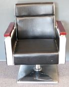 Retro barber's chair with chrome base and supports to arms with black and white leather covering and