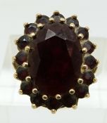 A 9ct gold ring set with garnets in a cluster (size K)