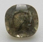 A loose cushion cut green sapphire showing rutile inclusions, approximately 0.7ct