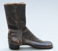 A miniature 19thC leather boot with stitched seams and riveted soles, possibly an apprentice