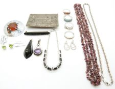 A collection of jewellery including white metal brooch depicting a castle, four silver rings, a