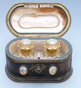 A 19th century cased pair of scent bottles, the case having gilt metal mounts to the tooled