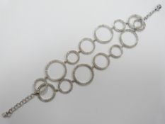 An 18ct white gold bracelet of modernistic circles set with diamonds, 25g