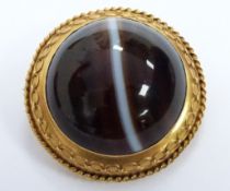 Victorian gold brooch set with a banded agate cabochon in a foiled mount with a glass compartment