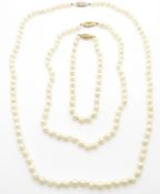 A cultured pearl necklace and matching bracelet with 9ct gold clasps and another cultured pearl