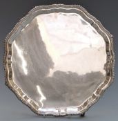 Hallmarked silver salver with gadrooned and rope twist rim raised on four scrolling feet,