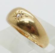 An 18ct gold ring set with a diamond in a star setting, 6.3g (size N)
