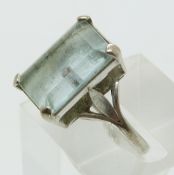 A white metal ring set with an emerald cut aquamarine (size N)