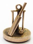 A 9ct gold fob with cricket bat, balls and stumps