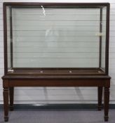 Early to mid 20thC mahogany museum or similar display cabinet with doors to each end, raised on