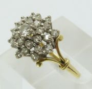 An 18ct gold ring set with diamonds in a cluster (size Q)
