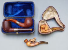 Two hallmarked silver mounted pipes in fitted case and two Meerschaum style pipes, one formed as a