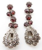 A pair of white metal earrings set with garnets and marcasite, marked 800
