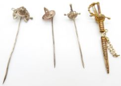 Four filigree stick pins, one in the form of a horseshoe and whip, two swords and a hat