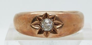 A 9ct rose gold ring set with an old cut diamond of approximately 0.2ct in a star setting (size R)