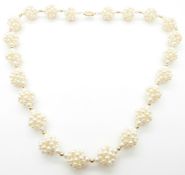 A necklace made up of pearls in clusters with 18ct gold clasp, 22.5cm drop