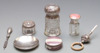 Three early 20th century silver top bottles, one with guilloché enamel decoration, an enamelled