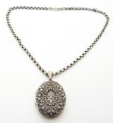 Victorian silver locket with raised decoration on a silver chain/ necklace
