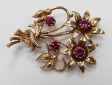 A 9ct gold brooch in the form of a bunch of flowers set with four synthetic rubies, 7.9g, width 5.