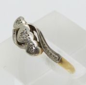 An 18ct gold ring set with diamonds in a platinum setting (size M)