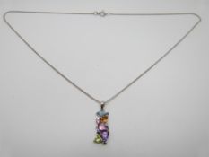 A 9ct white gold pendant set with heart cut topaz, citrine, peridot, amethyst, diamonds on a 9ct