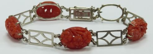 A 9ct white gold bracelet set with carved coral