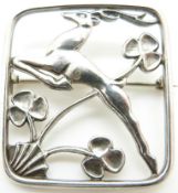 A silver George Tarrant brooch, designed by George Ballamy, depicting a jumping deer